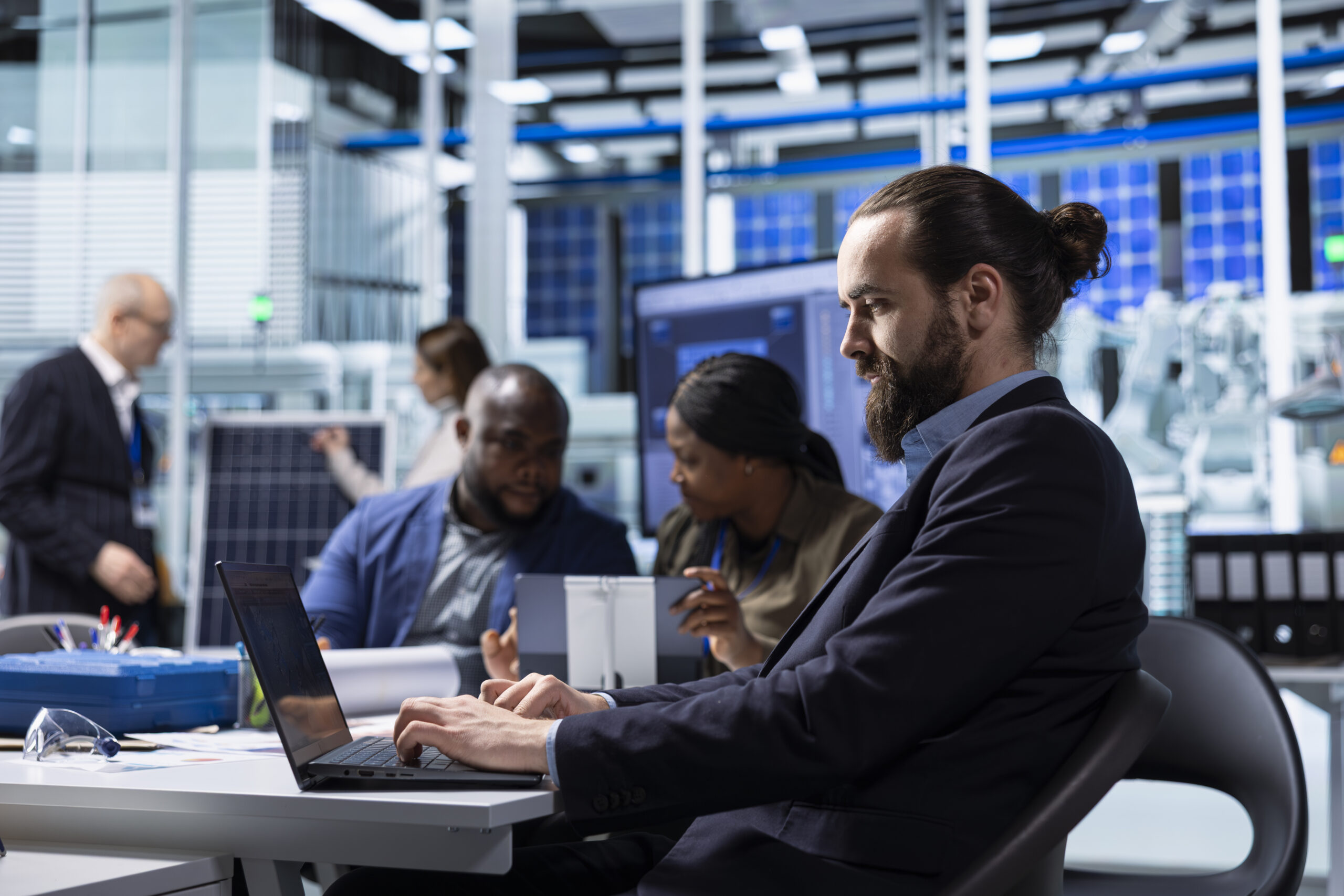 A diverse team of cloud and DevOps engineers working at laptops and monitors in a high-tech facility, representing how modern cloud infrastructure and DevOps practices power smarter and faster business operations. A diverse team of cloud and DevOps engineers working at laptops and monitors in a high-tech facility, representing how modern cloud infrastructure and DevOps practices power smarter and faster business operations.