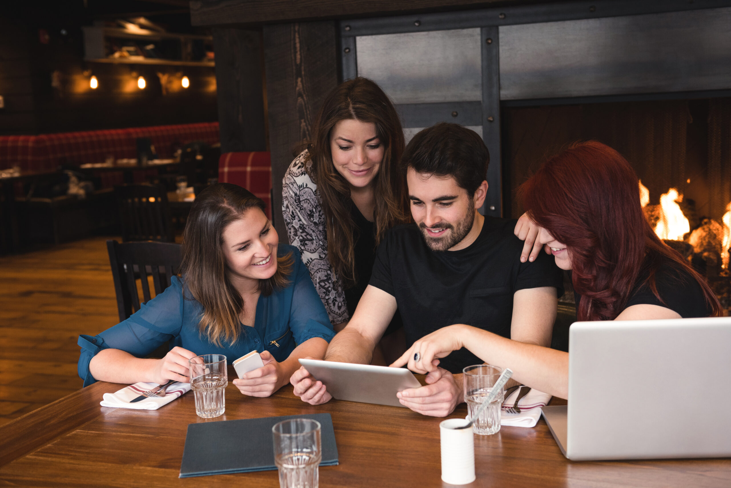 Business team collaborating on tablet and laptop devices, demonstrating how cloud technology is transforming businesses with modern digital solutions from Sherdil Cloud