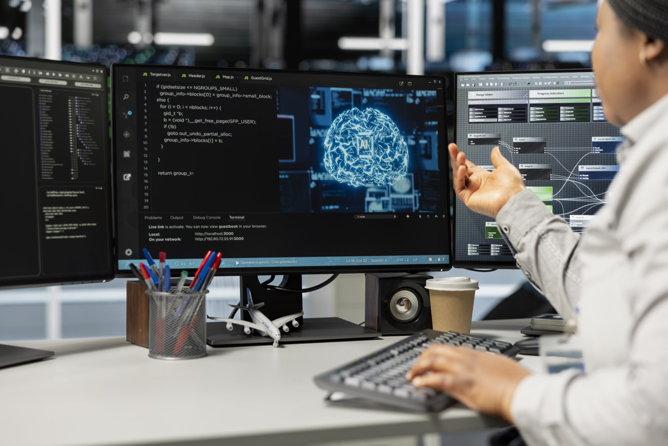 An IT professional working across multiple monitors displaying AI neural network visualizations, code, and system architecture diagrams, representing the concept of AIOps and its role in intelligent IT operations management for enterprise leaders. An IT professional working across multiple monitors displaying AI neural network visualizations, code, and system architecture diagrams, representing the concept of AIOps and its role in intelligent IT operations management for enterprise leaders.